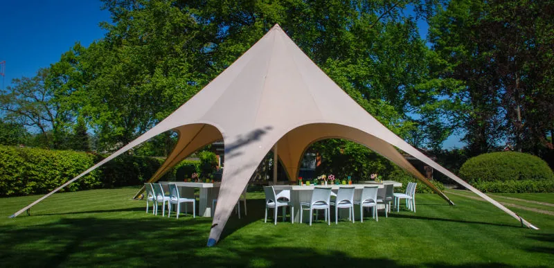 Startent 40 in een tuin met gedekte tafels en witte stoelen